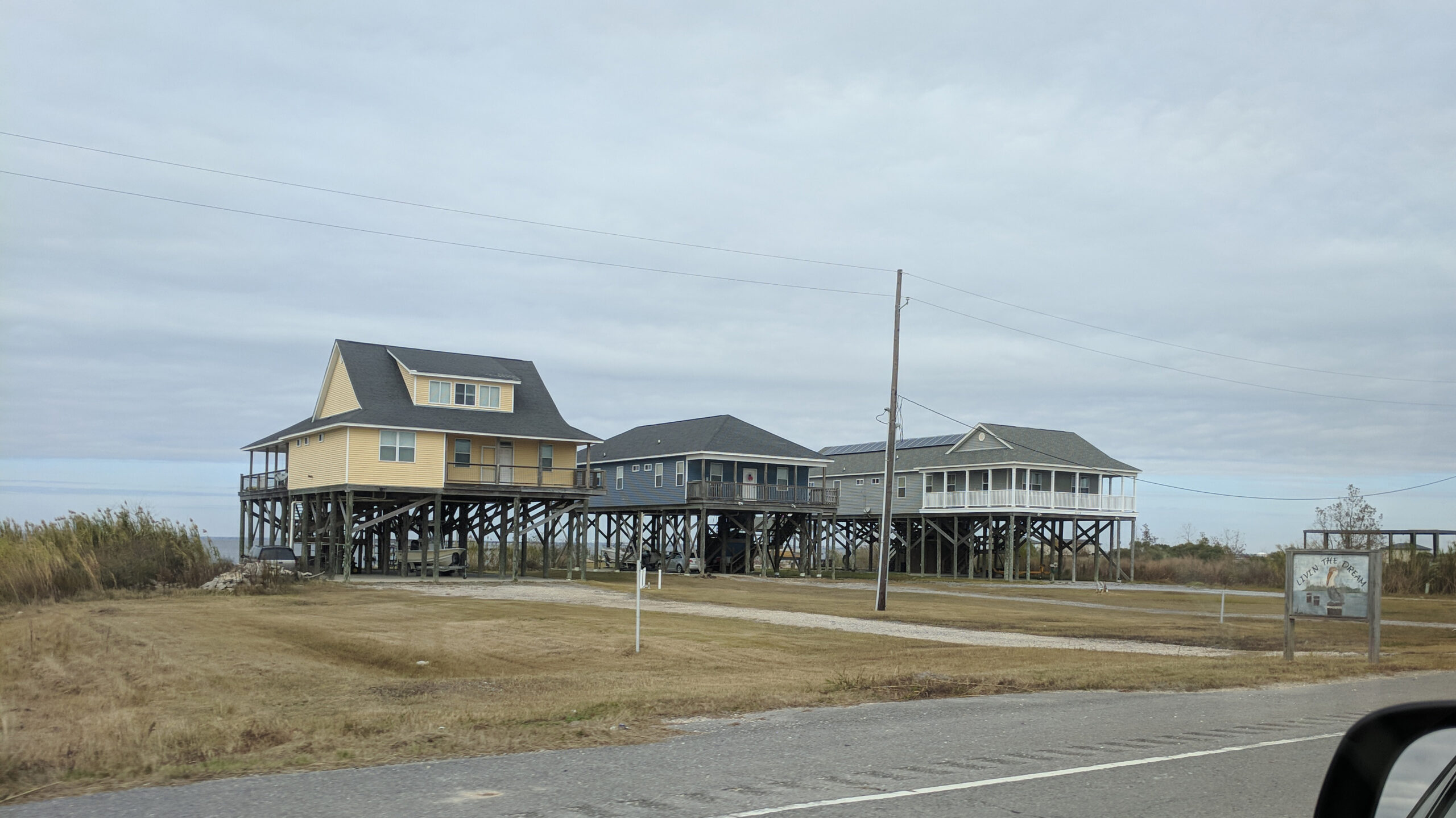 Raised homes such as these on St Catherine Island, LA are facing a perilous future with sea levels continuing to rise. Photo: Matt Drews