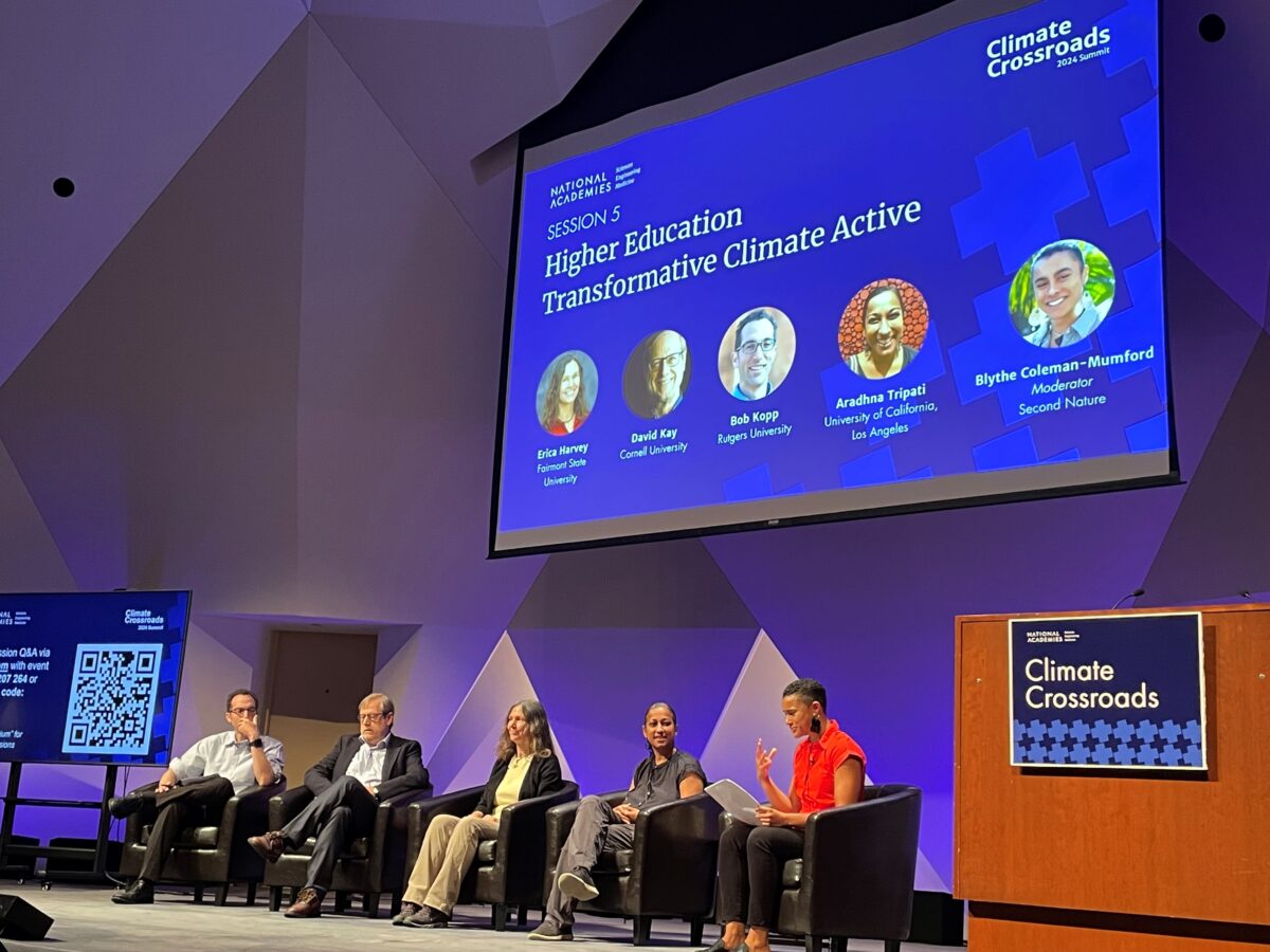 Panelists seated on stage at the conference