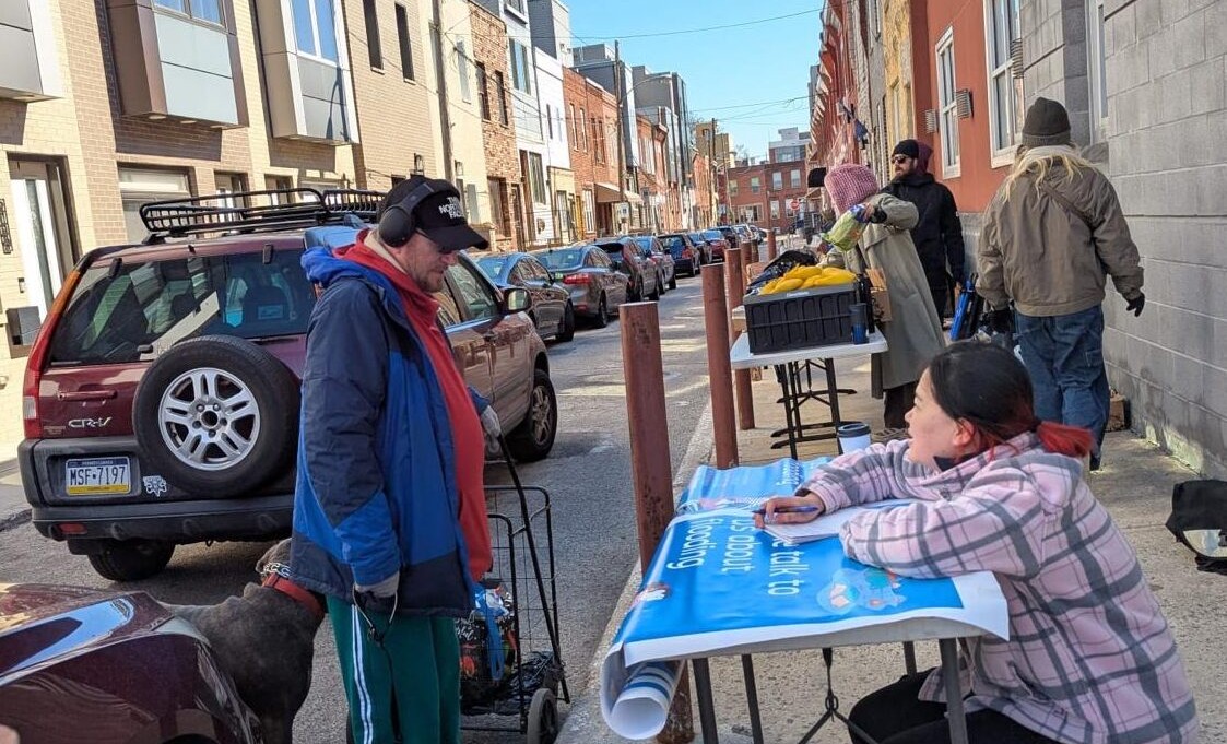 Researcher talking to community member