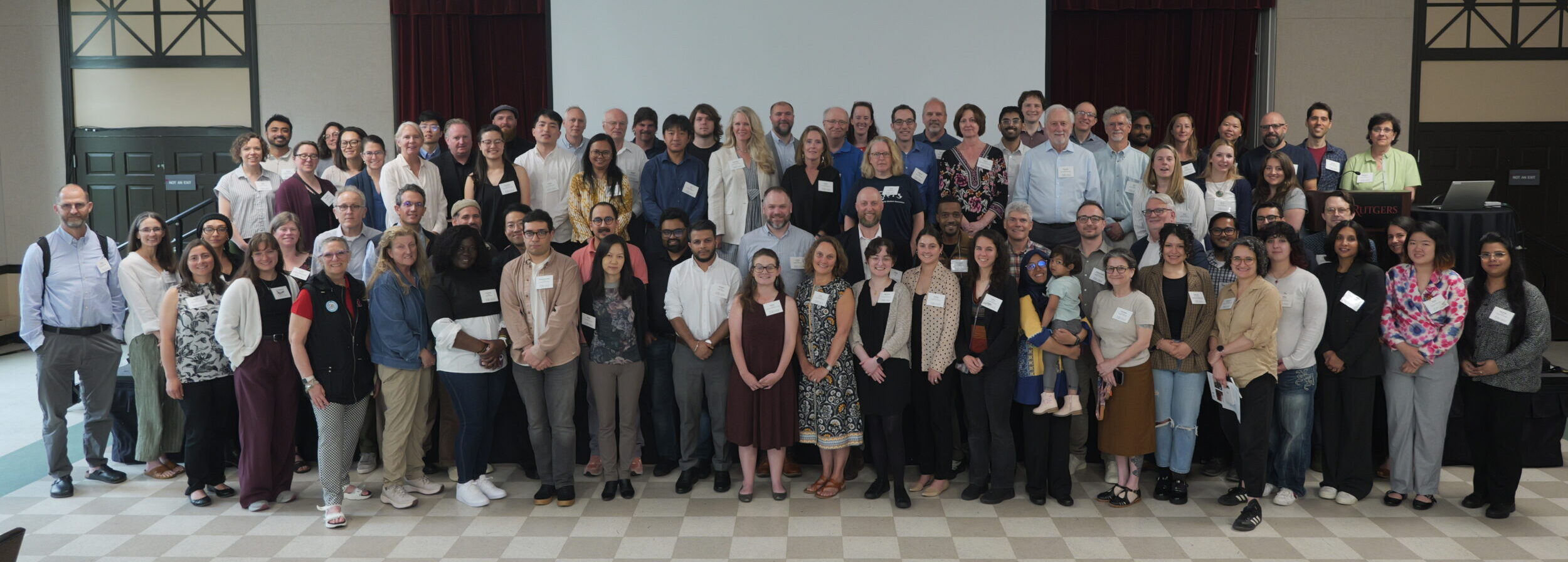 Picture of attendees at 2026 MACH annual meeting gathered in front of a stage
